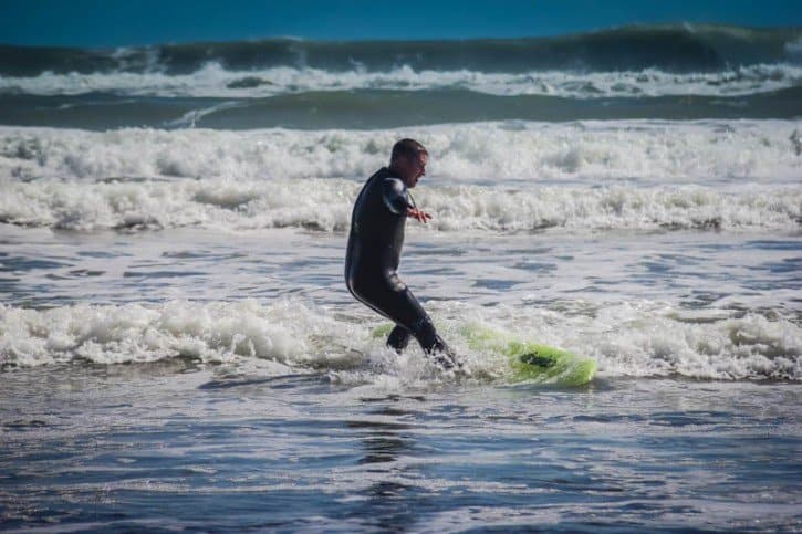 David Getting Up On The Board Piha Beach New Zealand