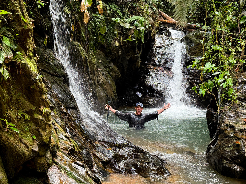 David Stock swimming in a waterfall pool at Mashpi Lodge, Ecuador