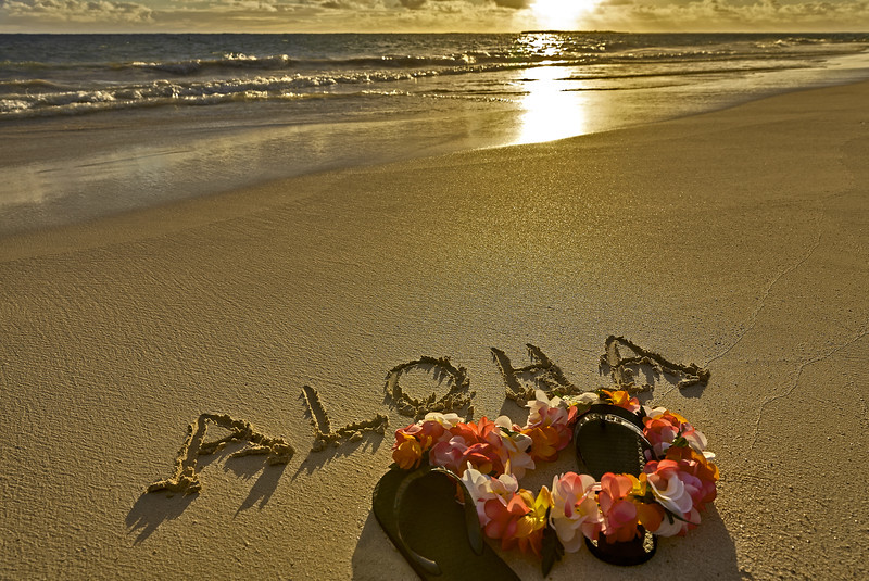 Tropical island beach aloha in sand with slippers in Maui