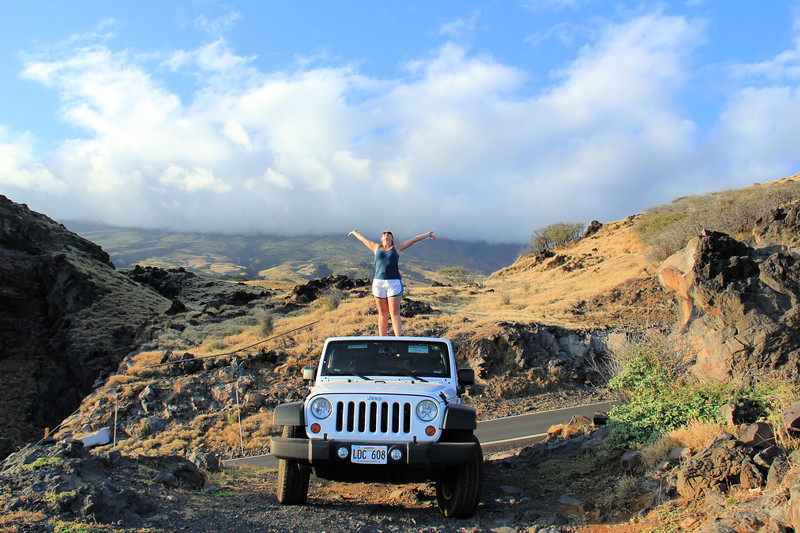 Lina Stock of 8 Wonders of the World Adventure Travel Blog standing on a Jeep